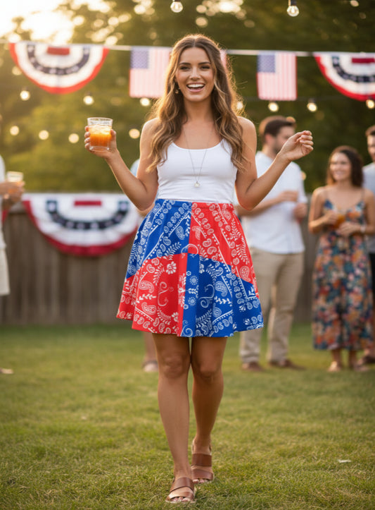 A beautful women wearing a red and Blue skirt with White Paisley Bandana Motif. She is at a 4th of July party.