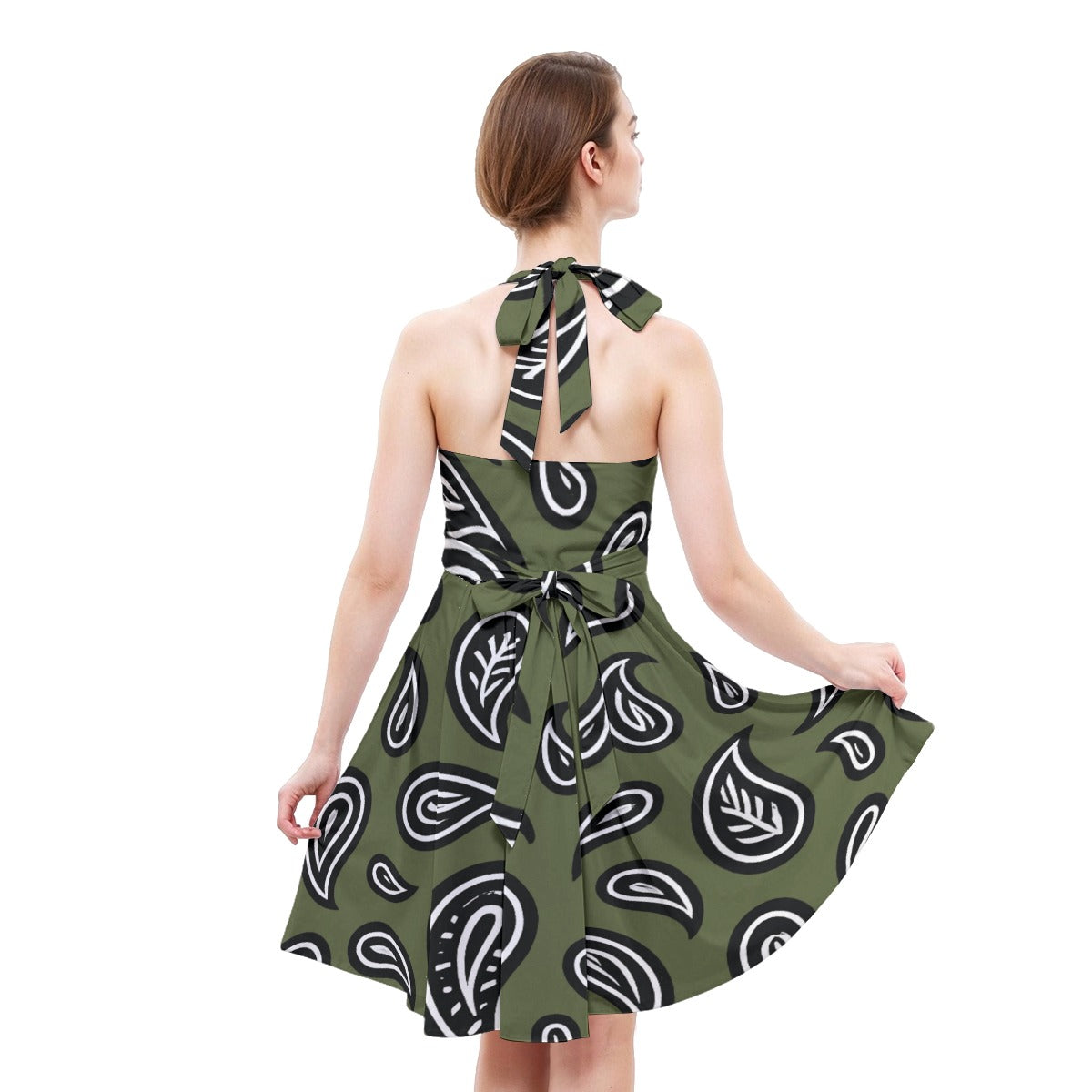 Woman wearing a green dress with white paisley pattern on a white background
