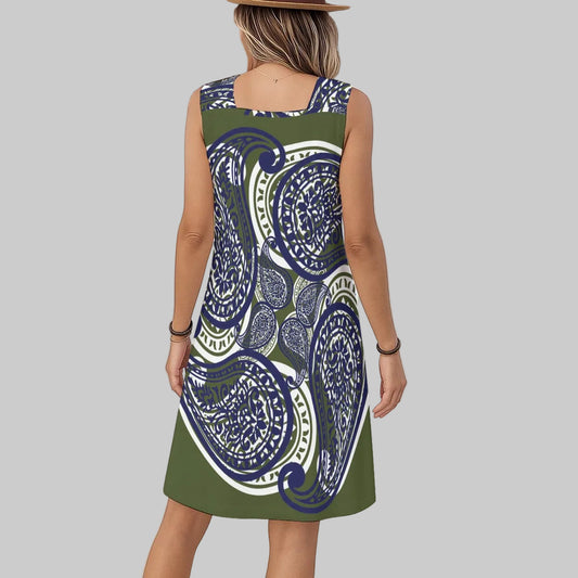 Woman wearing an army green paisley motiff dress with blue and white accents.