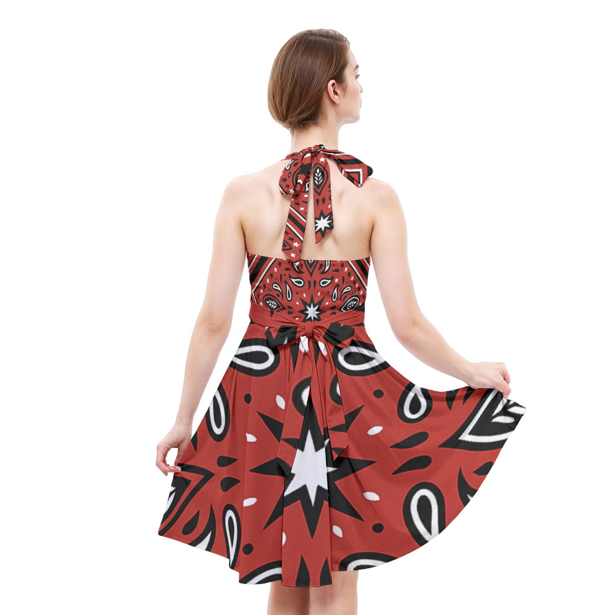 Woman wearing a red and black patterned dress on a white background