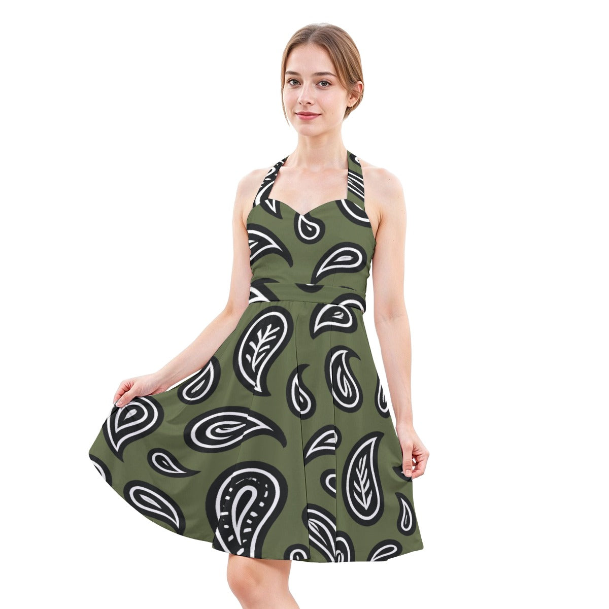 Woman wearing a green dress with black and white paisley pattern on a white background