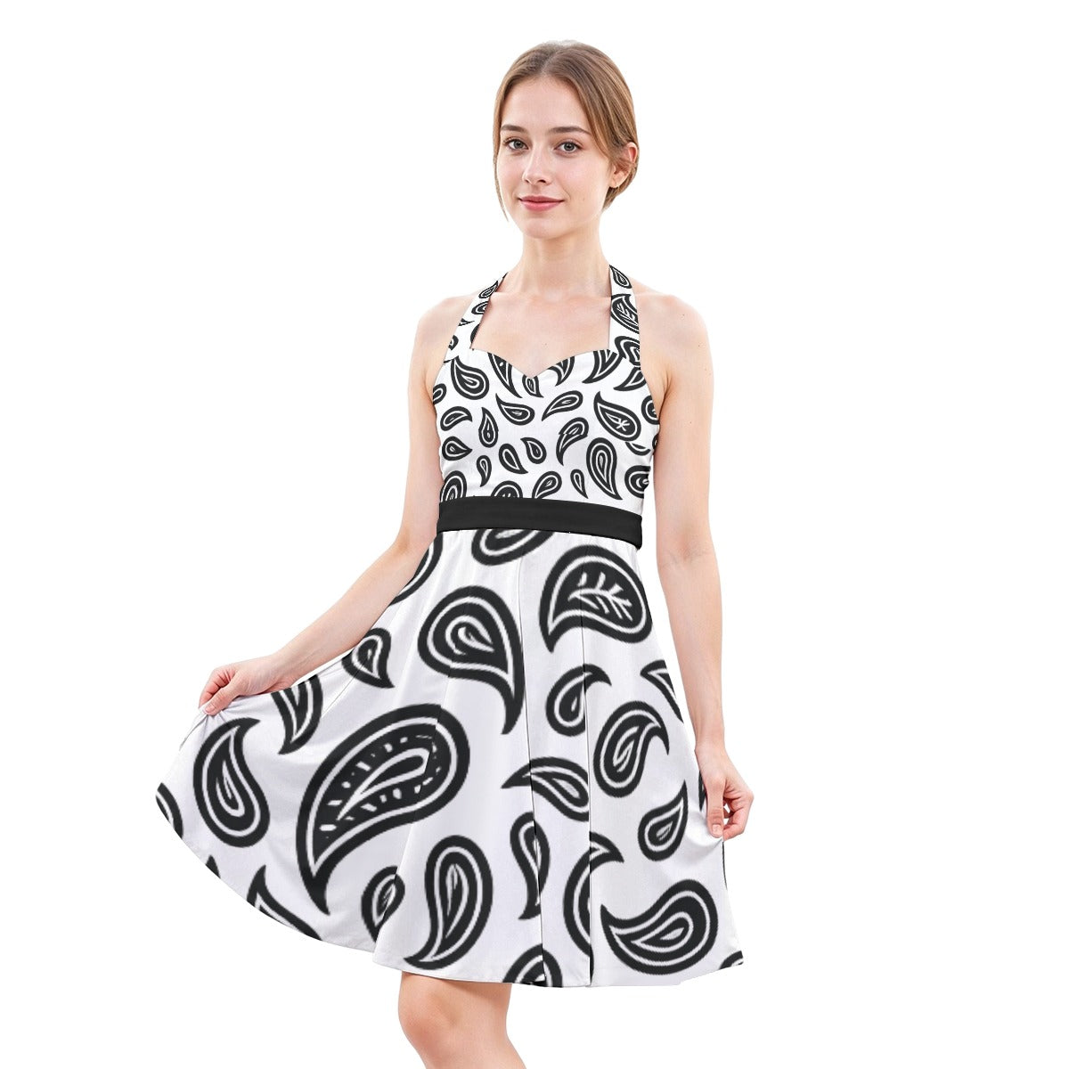 Woman wearing a white dress with black paisley pattern on a white background