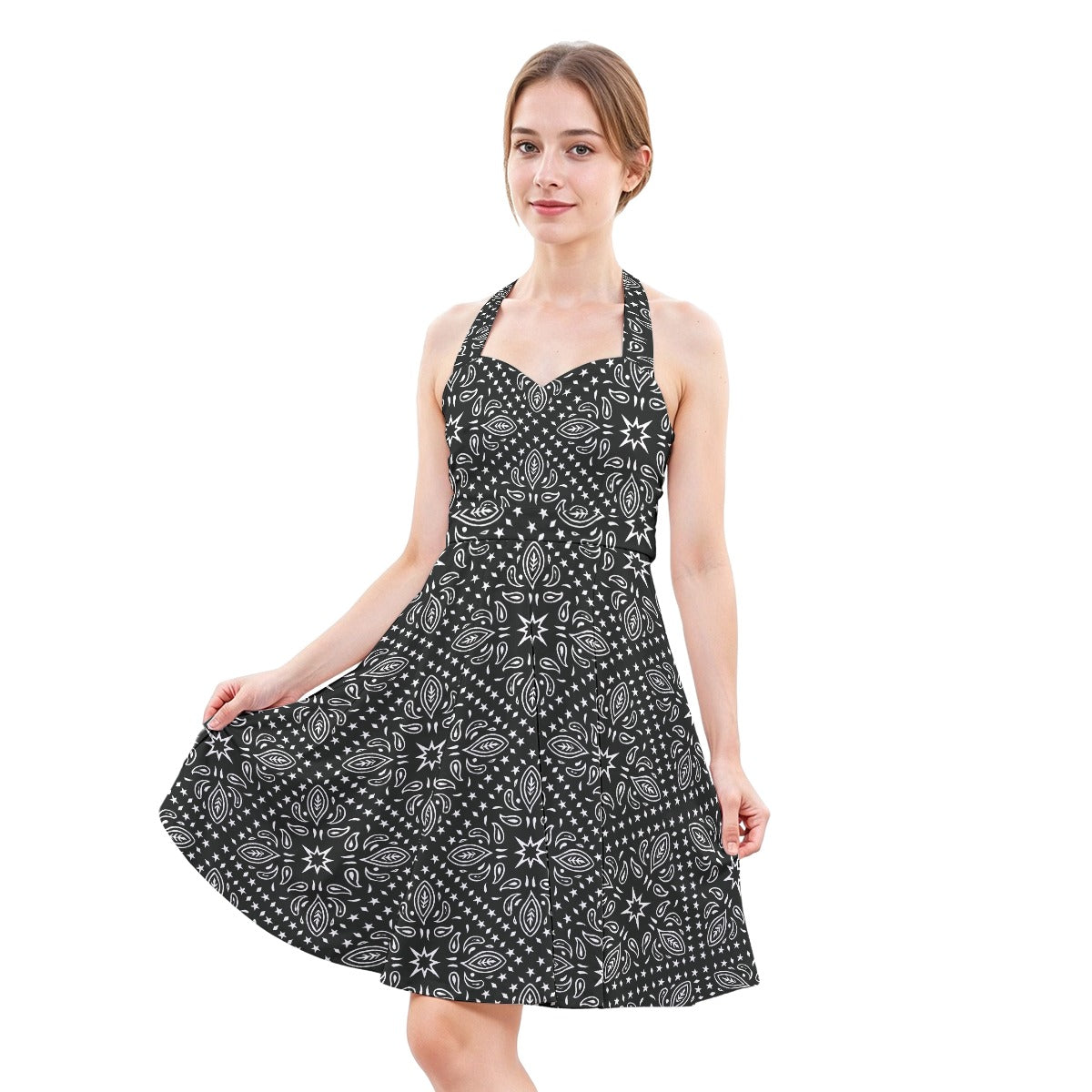Woman wearing a black and white patterned dress on a white background