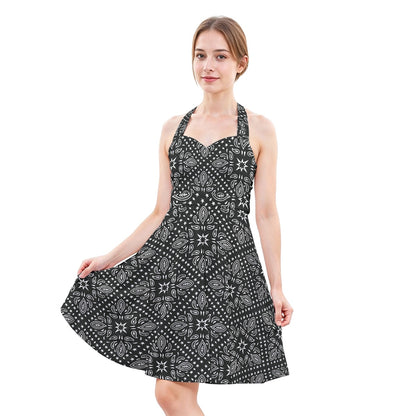 Woman wearing a black and white patterned dress on a white background