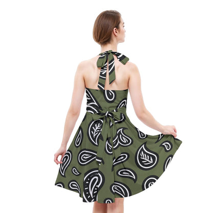 Woman wearing a green dress with white paisley pattern on a white background