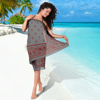 lady wrapped in grey with red sarong