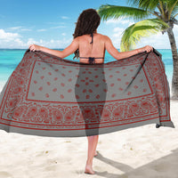 woman holding gray with red sarong